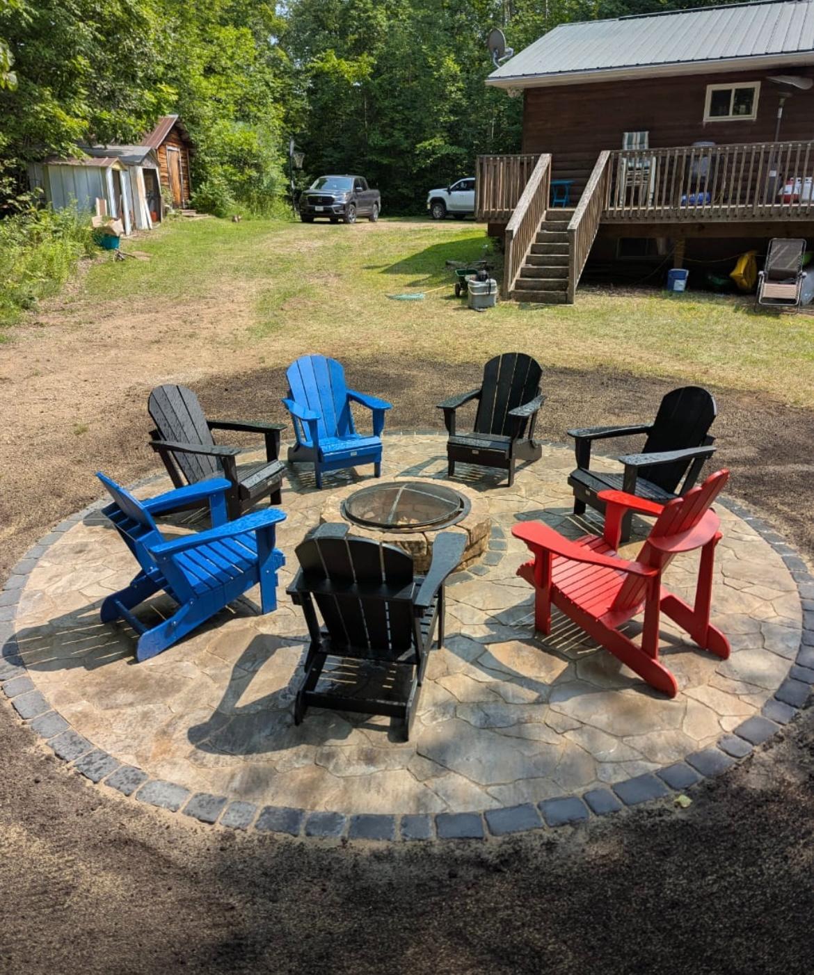KJ Landscape & Design team completing a fire pit installation project in Ottawa