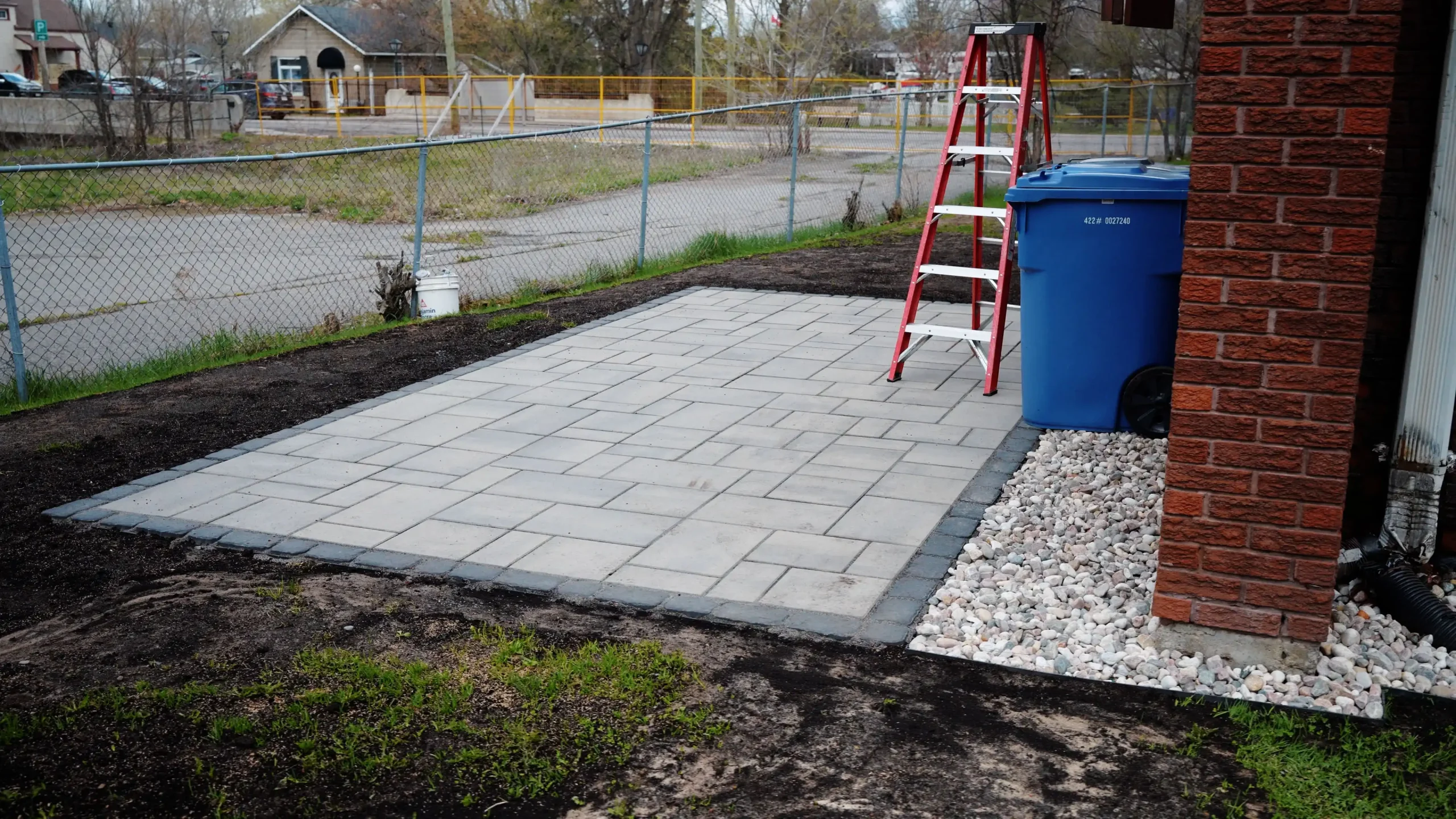 Retaining wall construction on a sloped residential yard in Manotick