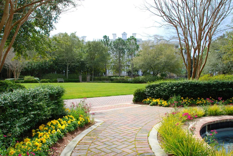 Front Walkway Ottawa – herringbone brick path through a landscaped garden.