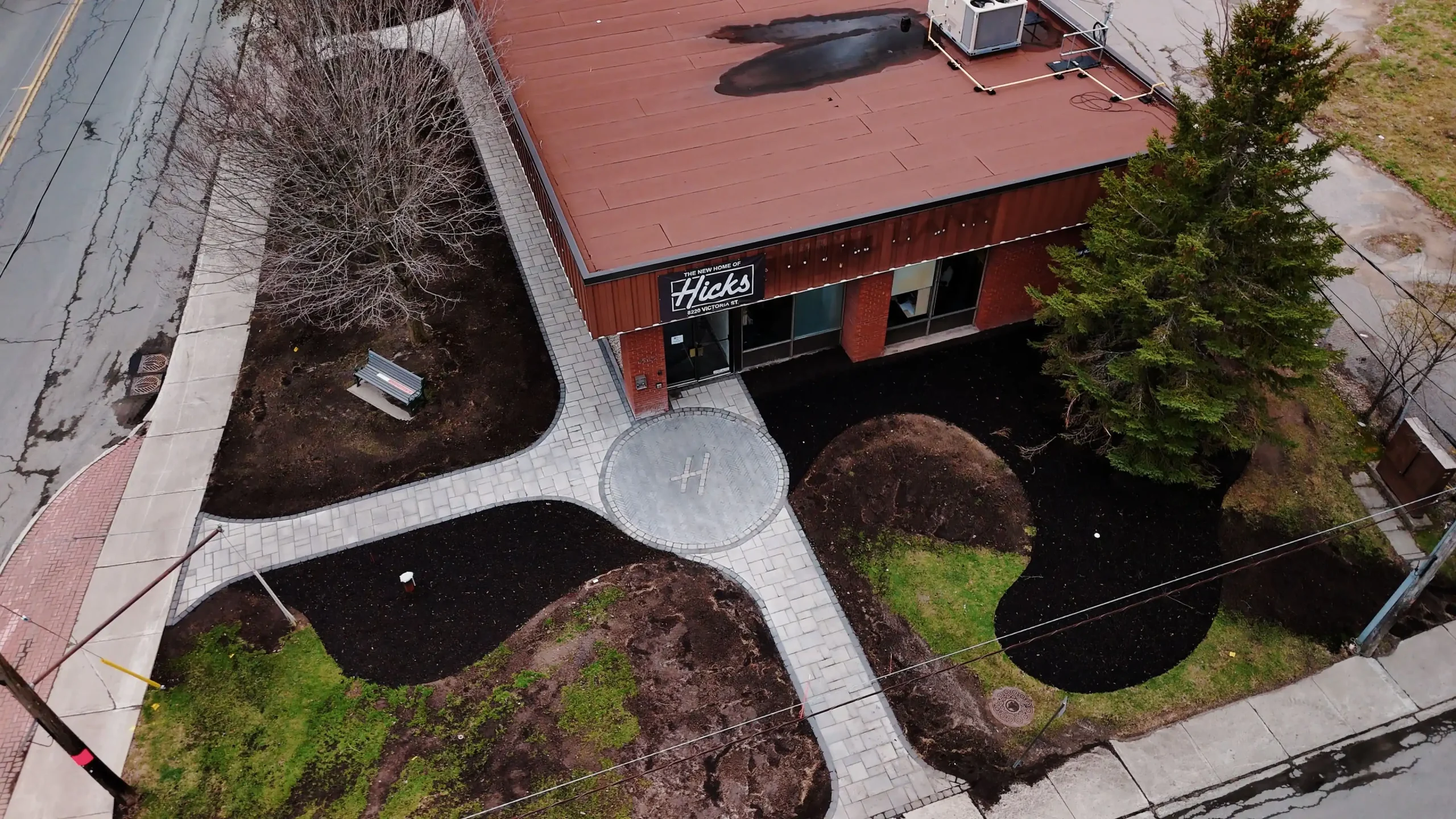 Aerial view of a completed Ottawa courtyard with paver pathways and mulched beds, built by KJ Landscape & Design's construction landscapers.