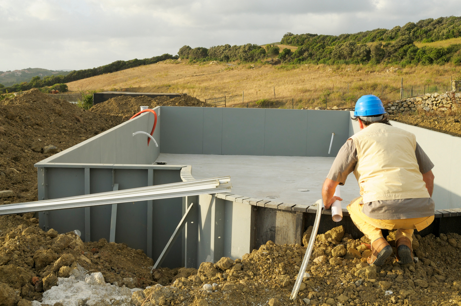 Pool Construction Permit Ottawa – contractor reviewing structural plans on site.